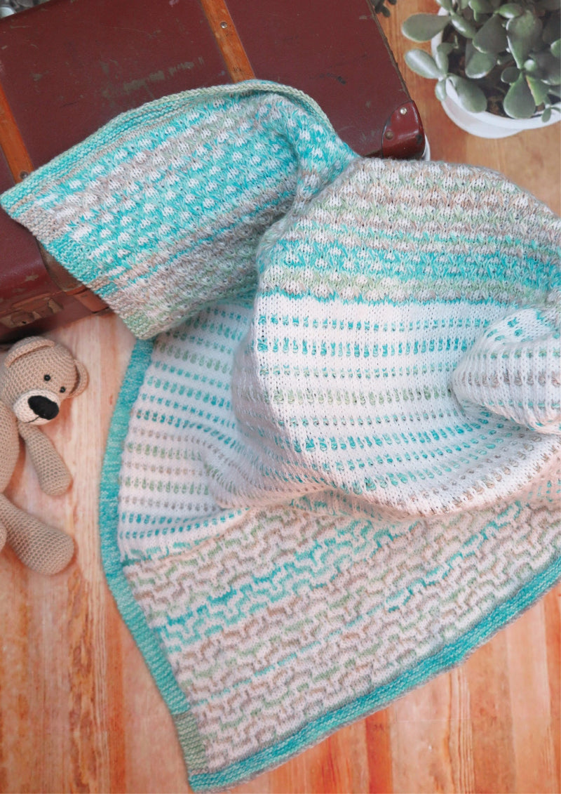 Knitted blanket with a striped pattern on a wooden surface