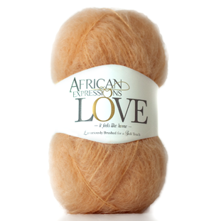 A ball of soft peach-colored yarn with a white paper label reading 'African Expressions Love' on a plain white background.